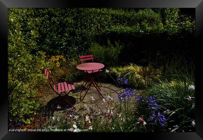 Floral Garden with a Rustic Iron Table and Chairs. Framed Print by Steve Gill