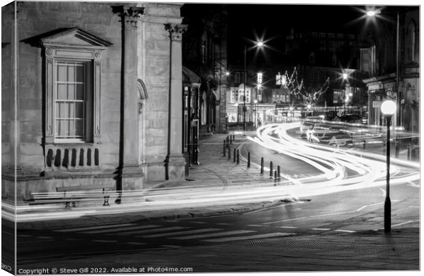 Streaks of  Car Headlights Along a Street at Night Canvas Print by Steve Gill