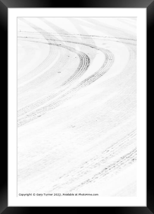 Curving tracks in the snow Framed Mounted Print by Gary Turner