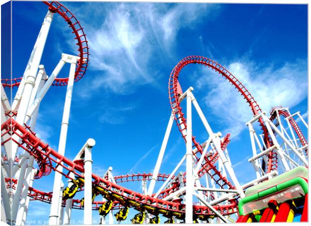 Roller coaster against blue sky. Canvas Print by john hill