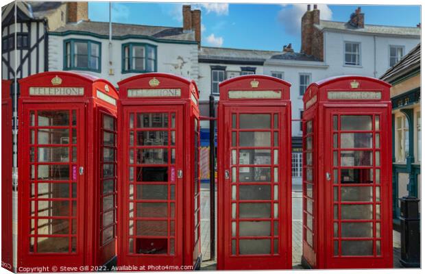 A Row of Four Red Traditional Telephone Boxes. Canvas Print by Steve Gill