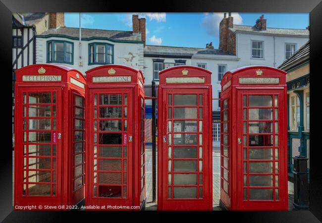 A Row of Four Red Traditional Telephone Boxes. Framed Print by Steve Gill
