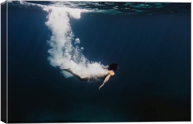 Woman diving underwater Canvas Print by Simo Wave