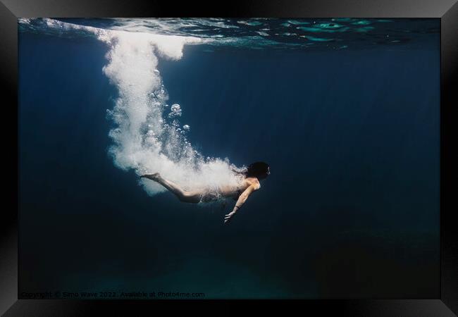 Woman diving underwater Framed Print by Simo Wave
