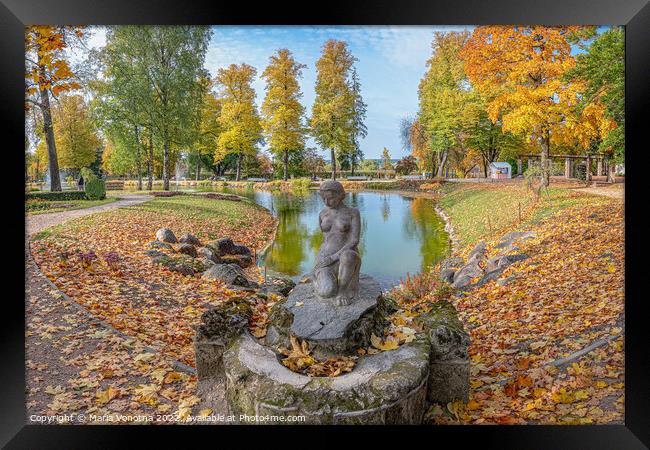 Autumn park landscape with small lake and female statue.  Framed Print by Maria Vonotna