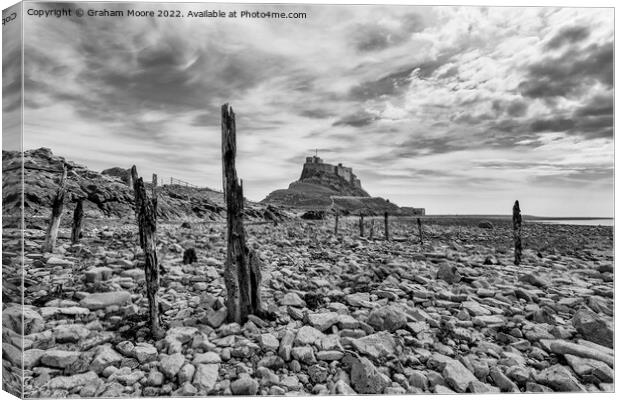 lindisfarne castle from the rocky shore monochrome Canvas Print by Graham Moore