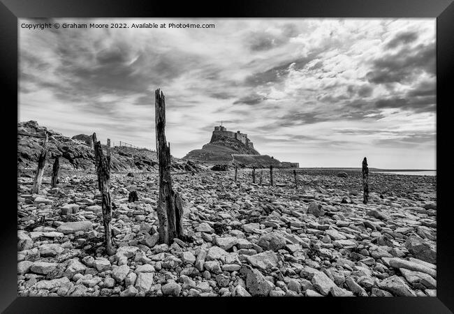 lindisfarne castle from the rocky shore monochrome Framed Print by Graham Moore