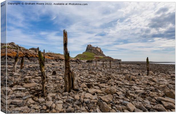 lindisfarne castle from the rocky shore Canvas Print by Graham Moore