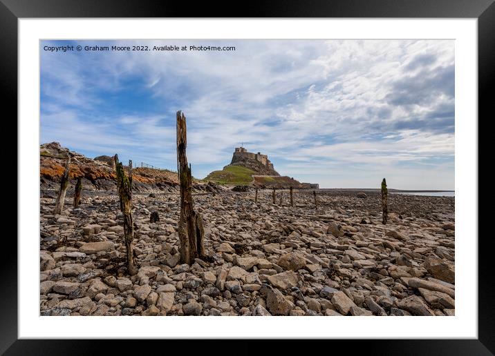lindisfarne castle from the rocky shore Framed Mounted Print by Graham Moore