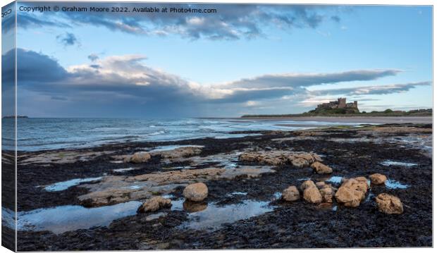 Bamburgh Castle from Harkness Rocks dusk Canvas Print by Graham Moore