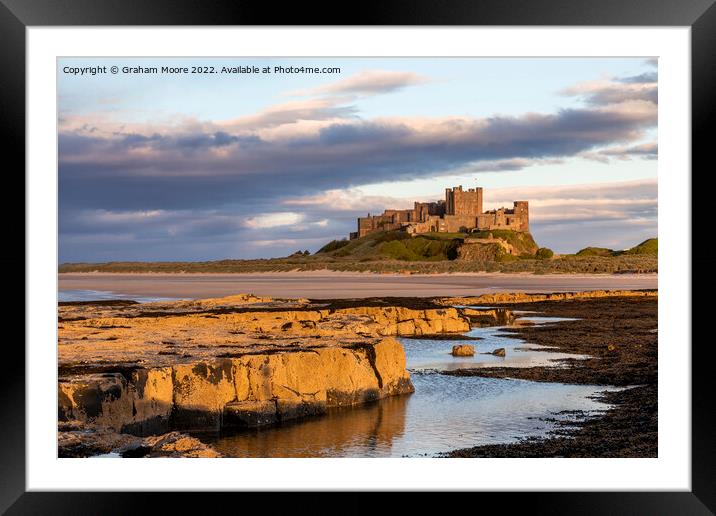 Bamburgh Castle from Harkness Rocks sunset Framed Mounted Print by Graham Moore
