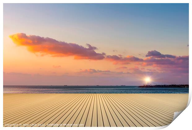 Sunset over the beach Print by Stan Lihai