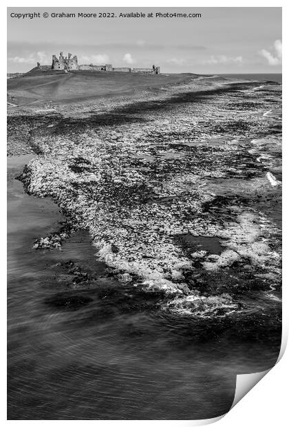 Dunstanburgh Castle from the sea elevated monochrome Print by Graham Moore