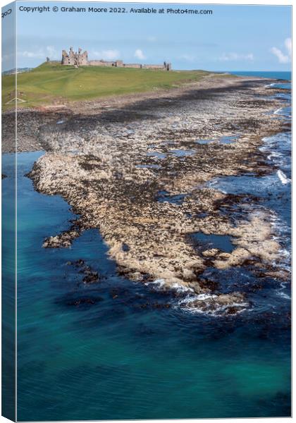 Dunstanburgh Castle from the sea elevated Canvas Print by Graham Moore