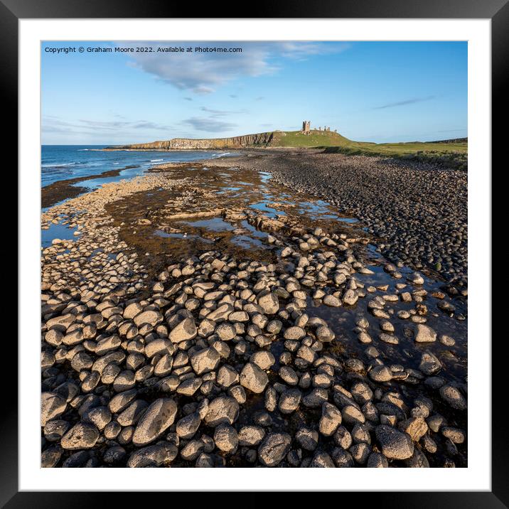 Dunstanburgh Castle from the north elevated evening Framed Mounted Print by Graham Moore