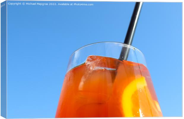 Refreshing orange summer cocktails with ice against a blue sky b Canvas Print by Michael Piepgras