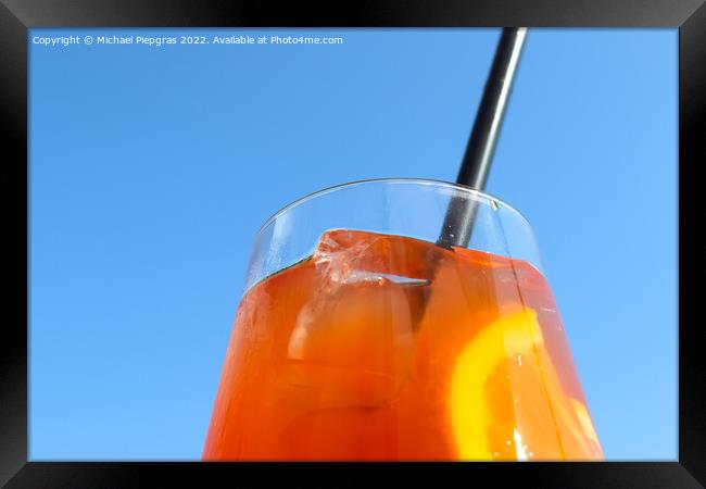 Refreshing orange summer cocktails with ice against a blue sky b Framed Print by Michael Piepgras