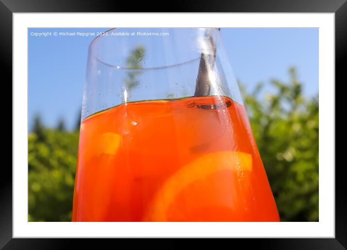 Refreshing orange summer cocktails with ice against a blue sky b Framed Mounted Print by Michael Piepgras