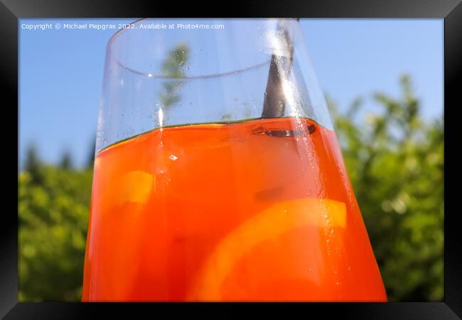 Refreshing orange summer cocktails with ice against a blue sky b Framed Print by Michael Piepgras