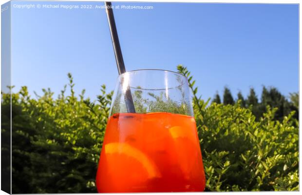 Refreshing orange summer cocktails with ice against a blue sky b Canvas Print by Michael Piepgras