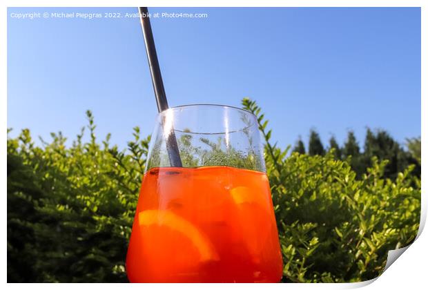 Refreshing orange summer cocktails with ice against a blue sky b Print by Michael Piepgras