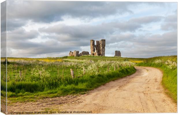 Winding road leading to a chirch ruin in Norfolk Canvas Print by Simon Bratt LRPS