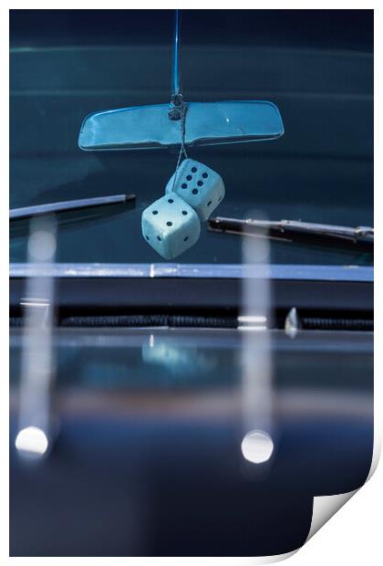 Fluffy dice hang from rear view mirror Print by Phil Crean