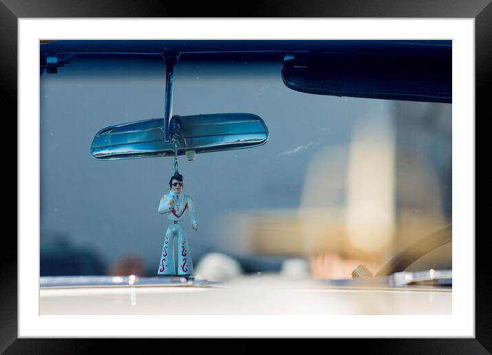 Elvis figure hangs fom rear view mirror Framed Mounted Print by Phil Crean
