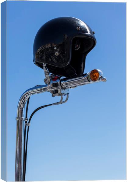 Open face crash helmet on handlebars of a motorcycle against a blue sky Canvas Print by Phil Crean