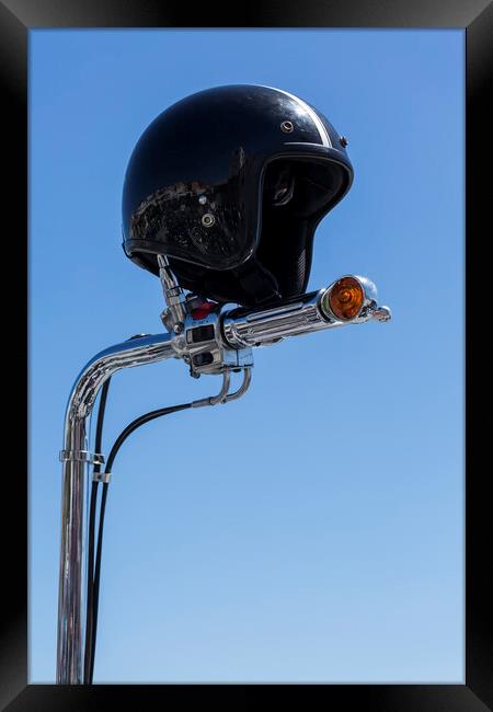 Open face crash helmet on handlebars of a motorcycle against a blue sky Framed Print by Phil Crean
