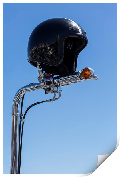 Open face crash helmet on handlebars of a motorcycle against a blue sky Print by Phil Crean