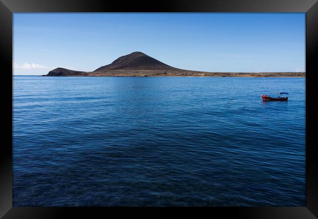 Red boat in the blue sea, El Medano, Tenerife Framed Print by Phil Crean