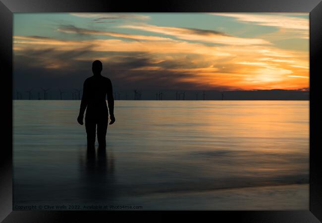 Iron man at sunset Framed Print by Clive Wells