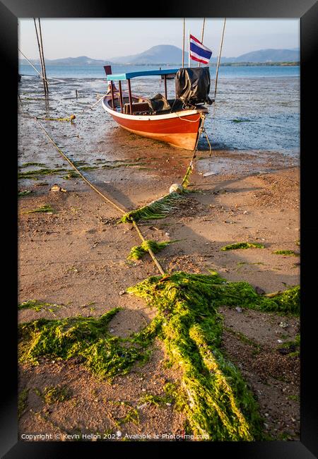 Thai long tail boat moored on sand Framed Print by Kevin Hellon