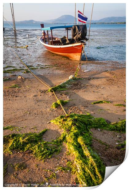 Thai long tail boat moored on sand Print by Kevin Hellon