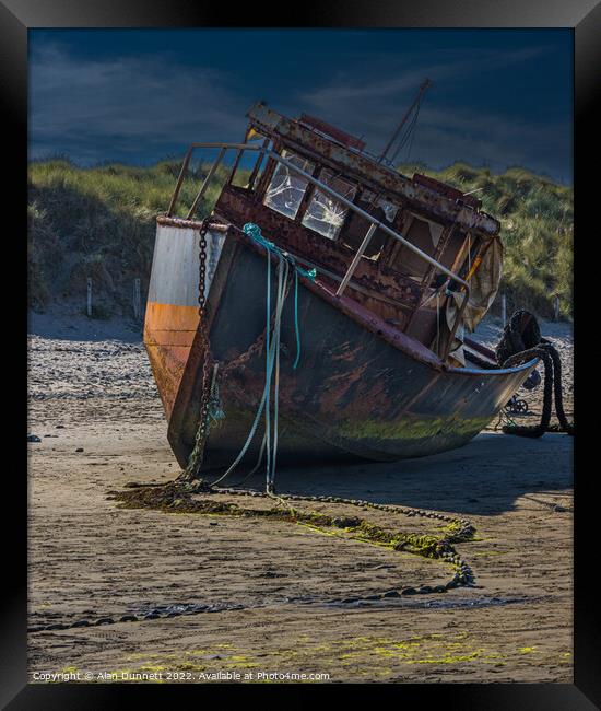 Boat on a beach Framed Print by Alan Dunnett
