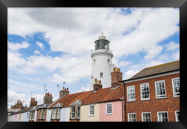 Southwold Lighthouse behind colourful houses Framed Print by Jason Wells