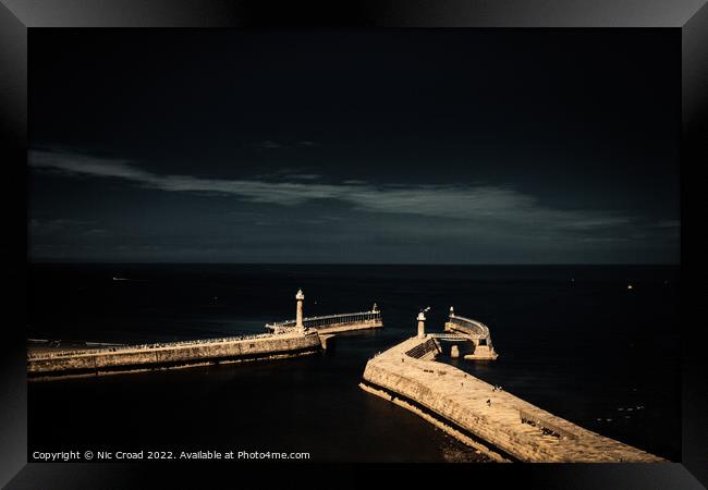 The piers of Whitby Framed Print by Nic Croad