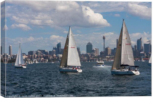 Yachts sailing in Sydney harbour witheCentral Business District, Canvas Print by Kevin Hellon