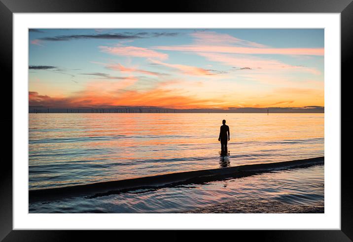 Silhouette of an Iron Man at sunset Framed Mounted Print by Jason Wells