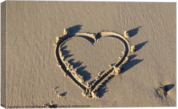 A beautiful heart shape painted into the sand of a baltic sea be Canvas Print by Michael Piepgras