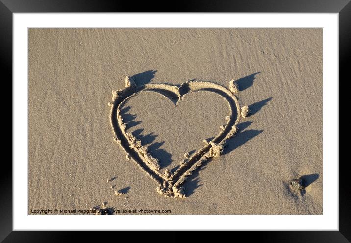 A beautiful heart shape painted into the sand of a baltic sea be Framed Mounted Print by Michael Piepgras