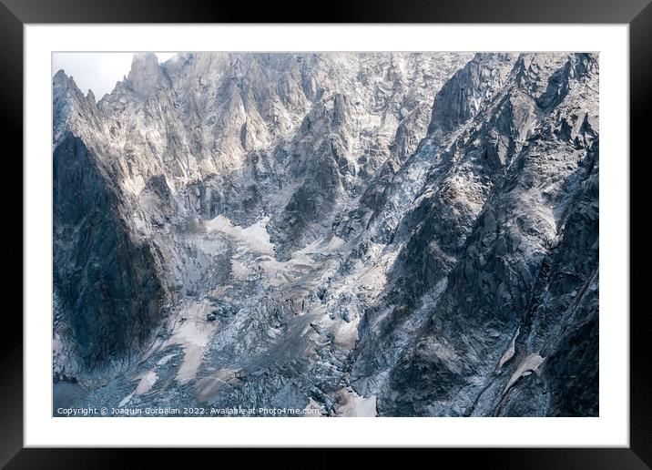 Rugged and dangerous mountain peaks high in the Alps losing thei Framed Mounted Print by Joaquin Corbalan