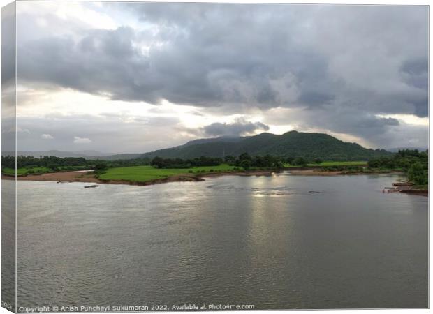 beautiful river near mountain under cloudy sky and a rice field Canvas Print by Anish Punchayil Sukumaran