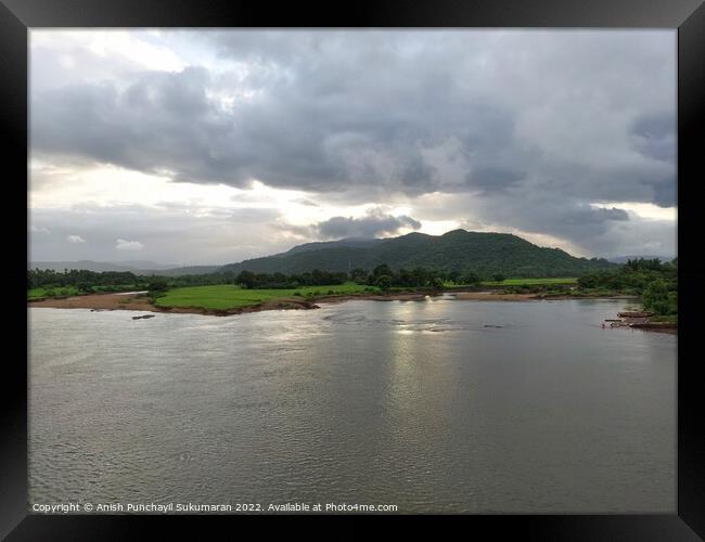 beautiful river near mountain under cloudy sky and a rice field Framed Print by Anish Punchayil Sukumaran
