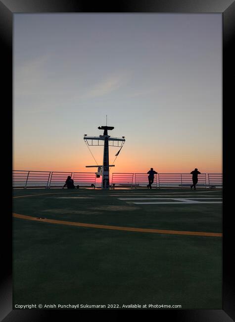 people enjoying sunset on the a helipad of a cruise ship Framed Print by Anish Punchayil Sukumaran