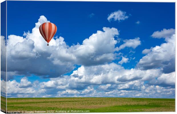 Colorful hot air balloons over green rice field. Canvas Print by Sergey Fedoskin
