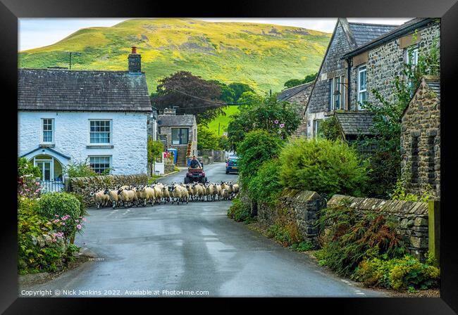 Sheep being herded through Barbon Village Cumbria Framed Print by Nick Jenkins