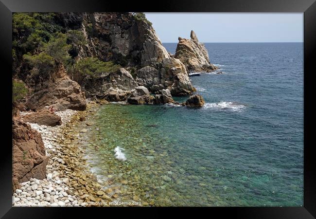 Pebble beach along the the Costa Brava coastline in Spain Framed Print by Lensw0rld 