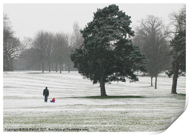 Man with child on sledge Print by Rick Parrott
